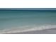 Serene beach view featuring crystal-clear turquoise waters and soft, white sand at 7701 Palm Dr, Holmes Beach, FL 34217