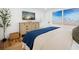 Bedroom features a dresser with a TV, stylish decor, and beach-themed wall art at 7701 Palm Dr, Holmes Beach, FL 34217