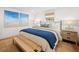 Beautifully staged bedroom with hardwood floors, soft lighting, and tranquil decor, promoting relaxation at 7701 Palm Dr, Holmes Beach, FL 34217