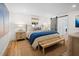 Bright bedroom with a large bed, wood floors, and a sliding barn door to an ensuite bathroom at 7701 Palm Dr, Holmes Beach, FL 34217