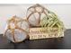 Decorated buoys with jute netting sit on top of books indicating the island's GPS coordinates at 7701 Palm Dr, Holmes Beach, FL 34217