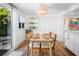 Bright dining area features modern lighting, a dining table, and an outdoor patio view at 7701 Palm Dr, Holmes Beach, FL 34217
