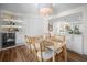 Bright dining room with dining table, modern light fixture, and view into the kitchen at 7701 Palm Dr, Holmes Beach, FL 34217