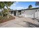 A charming home exterior with a neatly landscaped front yard and well-maintained driveway at 7701 Palm Dr, Holmes Beach, FL 34217