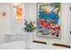 Bright and airy dining room with decor, modern accents, and a vibrant Florida art piece at 7701 Palm Dr, Holmes Beach, FL 34217