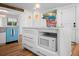 Bright kitchen with stainless steel appliances, custom cabinetry, and center island with microwave at 7701 Palm Dr, Holmes Beach, FL 34217