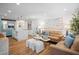 Open-concept living room and kitchen with modern finishes and comfortable seating at 7701 Palm Dr, Holmes Beach, FL 34217