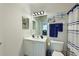 Well-lit bathroom features a vanity with storage and a shower with decorative towels and accessories at 8211 Summer Greens Ter, Bradenton, FL 34212