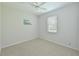 Bright bedroom features carpet, a ceiling fan, window, and wall art, creating a cozy and inviting space at 8211 Summer Greens Ter, Bradenton, FL 34212