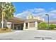 Beautiful clubhouse exterior with a porte cochere, stone accents and lush landscaping at 8211 Summer Greens Ter, Bradenton, FL 34212