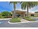 Beautiful clubhouse featuring stone accents and lush landscaping, offering a warm welcome to residents and guests at 8211 Summer Greens Ter, Bradenton, FL 34212