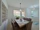 Dining room features a large table, seating for six, pendant lighting, and a view to the exterior at 8211 Summer Greens Ter, Bradenton, FL 34212