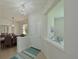 Bright entryway featuring a white front door, tile flooring, and decorative lighting fixtures at 8211 Summer Greens Ter, Bradenton, FL 34212