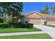 Charming single-story home featuring a well-manicured lawn and attached two-car garage at 8211 Summer Greens Ter, Bradenton, FL 34212
