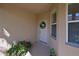 Inviting front porch with a decorative wreath and potted plants at 8211 Summer Greens Ter, Bradenton, FL 34212