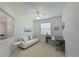 Bright home office/bedroom featuring a ceiling fan, a window, and a comfortable seating area at 8211 Summer Greens Ter, Bradenton, FL 34212