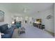 Bright and airy living room with comfortable seating, ceiling fan, and television at 8211 Summer Greens Ter, Bradenton, FL 34212