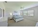 Spacious main bedroom with a ceiling fan, and a large window providing natural light at 8211 Summer Greens Ter, Bradenton, FL 34212