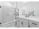 Bright bathroom features a marble tiled shower, modern fixtures, and a sleek vanity with storage at 8227 Nevis Run, Bradenton, FL 34202