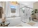 Luxurious bathroom featuring a soaking tub, a modern glass-enclosed shower, and elegant marble accents at 8227 Nevis Run, Bradenton, FL 34202