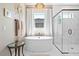 Luxurious bathroom featuring a soaking tub, a modern glass-enclosed shower, and elegant marble accents at 8227 Nevis Run, Bradenton, FL 34202