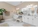 Bright bathroom features double sinks, vanity area, and plant for spa-like feel at 8227 Nevis Run, Bradenton, FL 34202
