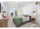 Brightly lit bedroom with a large window, stylish decor, and comfortable furnishings at 8227 Nevis Run, Bradenton, FL 34202