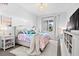Stylish bedroom with vibrant decor, a cozy bed, and a large window with ample natural light at 8227 Nevis Run, Bradenton, FL 34202