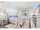 Stylish bedroom with vibrant decor, a cozy bed, and a large window with ample natural light at 8227 Nevis Run, Bradenton, FL 34202