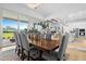 Open floor plan dining room featuring wood table, candle decor, and sliding glass doors to a backyard view at 8227 Nevis Run, Bradenton, FL 34202
