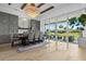 Bright dining area with a grand chandelier, large windows, and outdoor patio access at 8227 Nevis Run, Bradenton, FL 34202