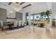 Elegant dining area with modern gray cabinets, a large table, and patio access at 8227 Nevis Run, Bradenton, FL 34202