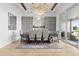 Elegant dining room with modern gray cabinets, a large table, and outdoor access at 8227 Nevis Run, Bradenton, FL 34202