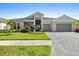 Beautiful single-story home with a well-manicured lawn and a two-car garage at 8227 Nevis Run, Bradenton, FL 34202