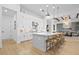 Open kitchen featuring a large island with seating, white cabinetry, and stainless steel appliances at 8227 Nevis Run, Bradenton, FL 34202