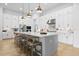 Modern kitchen featuring white cabinets, island with seating, and stainless steel appliances at 8227 Nevis Run, Bradenton, FL 34202