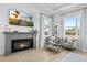 Elegant living room with a fireplace, comfortable seating, and large windows offering scenic views at 8227 Nevis Run, Bradenton, FL 34202