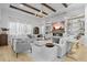 Bright living room with beamed ceiling, decorative fireplace and open concept design at 8227 Nevis Run, Bradenton, FL 34202