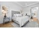 Bright and airy main bedroom boasts hardwood floors, neutral tones and a large window at 8227 Nevis Run, Bradenton, FL 34202