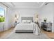 Bright and airy main bedroom boasts hardwood floors, neutral tones, tray ceiling and a large window at 8227 Nevis Run, Bradenton, FL 34202