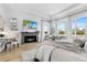 Spacious main bedroom features a cozy fireplace, sitting area, and plenty of natural light from the large windows at 8227 Nevis Run, Bradenton, FL 34202
