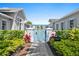 Charming meditation lawn entrance with a blue pergola and lush landscaping, creating a serene and welcoming space at 8227 Nevis Run, Bradenton, FL 34202
