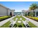 Relaxing meditation lawn with white Adirondack chairs, perfect for unwinding in a tranquil outdoor setting at 8227 Nevis Run, Bradenton, FL 34202
