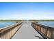 Picturesque pier with benches overlooking a serene lake and fountain, offering a peaceful retreat at 8227 Nevis Run, Bradenton, FL 34202