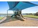 Fun-filled playground with slides and climbing structures, covered by a sun shade for  at 8227 Nevis Run, Bradenton, FL 34202