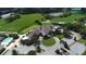 Aerial view of the community clubhouse with manicured landscaping, golf course, and parking at 9411 Forest Hills Cir, Sarasota, FL 34238