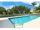 Inviting community pool featuring clear blue water and a spacious deck area for relaxation at 9411 Forest Hills Cir, Sarasota, FL 34238