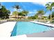 Inviting community pool featuring clear blue water and a spacious deck area with lounge chairs at 9411 Forest Hills Cir, Sarasota, FL 34238