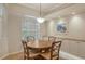 Charming dining area with custom cabinets, granite countertops, and a window view at 9411 Forest Hills Cir, Sarasota, FL 34238