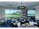 Tasteful dining room featuring modern decor, well-placed tables, and panoramic golf course views at 9411 Forest Hills Cir, Sarasota, FL 34238